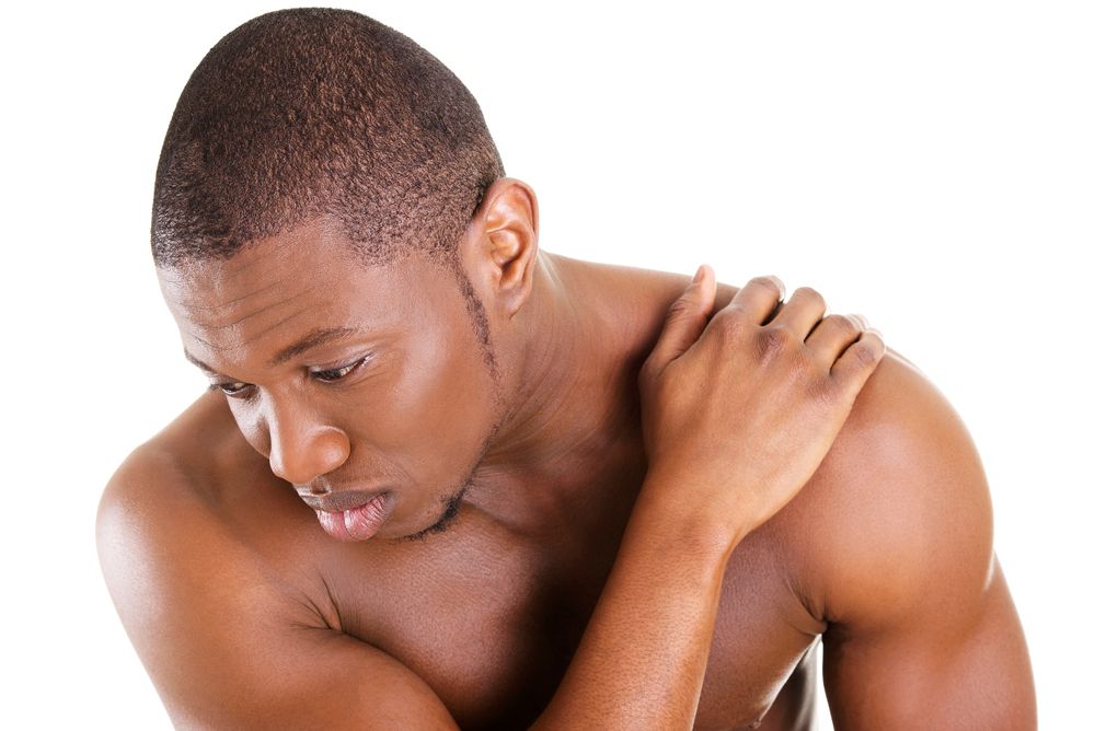man suffering from chronic pain in his shoulder